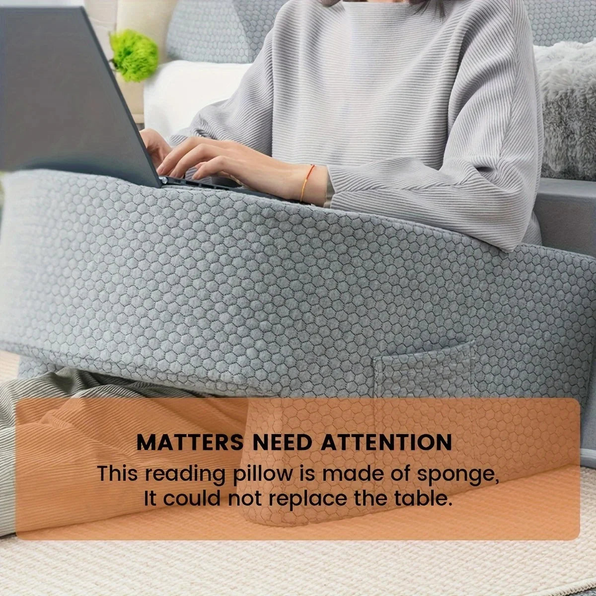Person using a Portable Desk Pad while sitting comfortably with a reading pillow made of sponge.